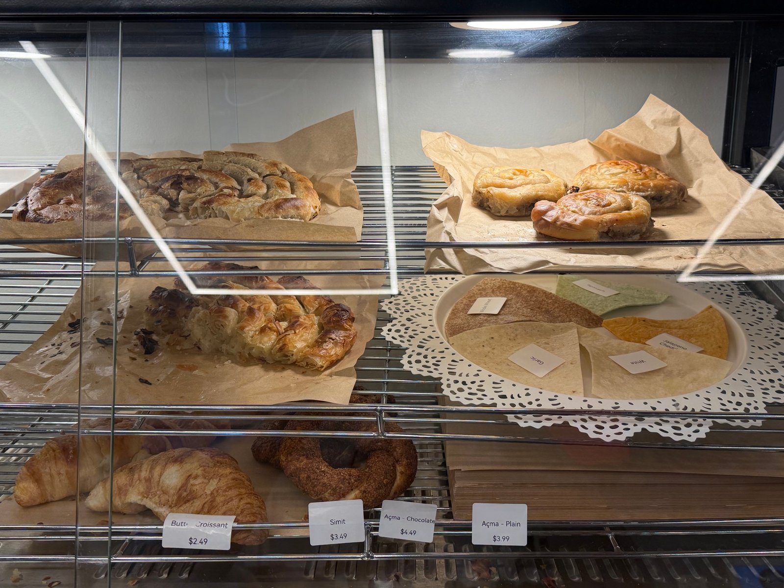 Fresh borek, simit, and croissants in the pastry case